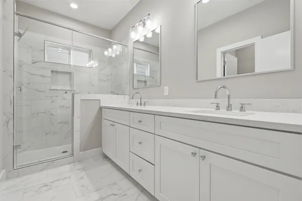 a bathroom with double sink and a mirror