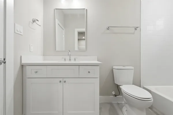 an empty room with a ceiling fan and carpet