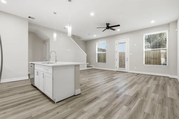 a kitchen with stainless steel appliances a refrigerator sink and stove