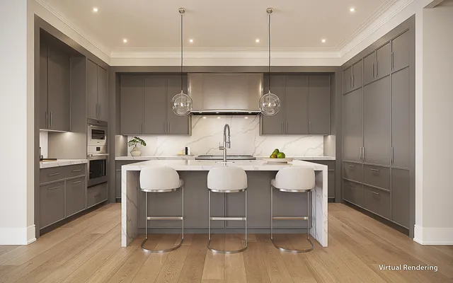 a room with kitchen island granite countertop a white cabinets and stainless steel appliances
