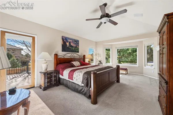 a spacious bedroom with a bed a couch and a window