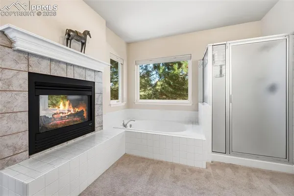 a living room with a fireplace and a flat screen tv