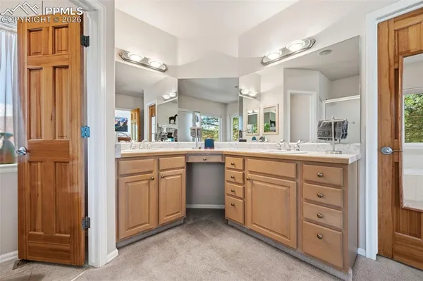 a bathroom with a double vanity sink a mirror and a bathtub