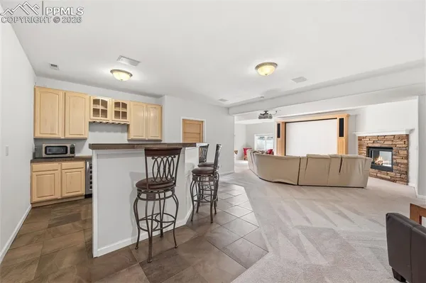 a living room with furniture and a dining table with kitchen view