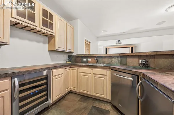 a kitchen with stainless steel appliances granite countertop a sink and dishwasher a stove top oven with wooden floor