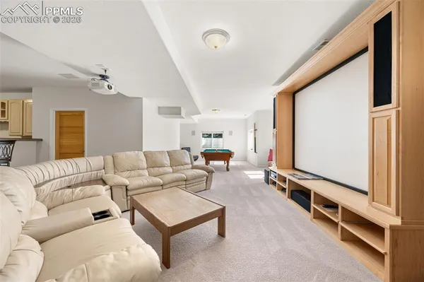 a living room with furniture gym equipment and a flat screen tv