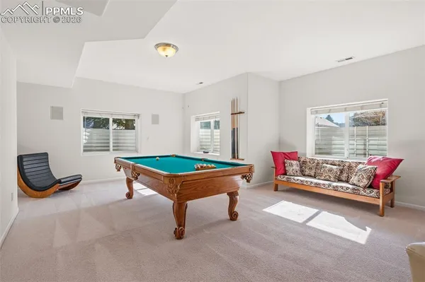 a living room with furniture gym equipment and a window