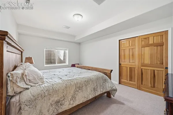 a bed sitting in a bedroom next to a window