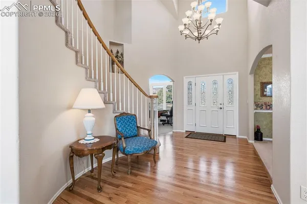 a view of entryway with wooden floor and a table