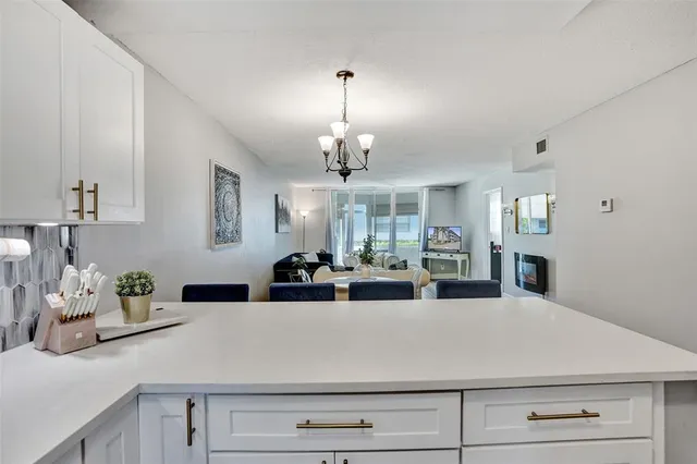 a view of a hallway with a chandelier furniture and a chandelier