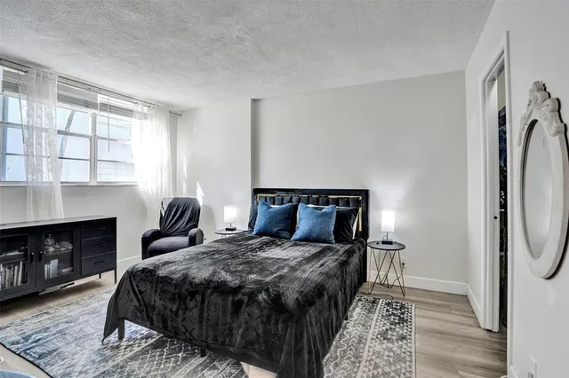 a bedroom with a bed a fireplace and window