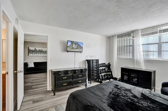 a bedroom with a bed and a television