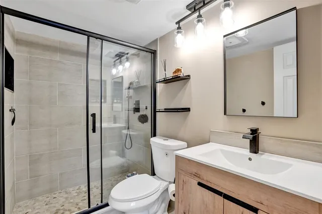 a bathroom with a sink toilet and shower