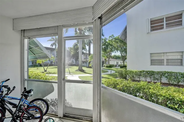 a view of a porch with a table and chairs