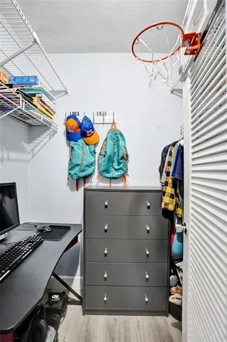 a front view of a multi story residential apartment building with yard and sign board
