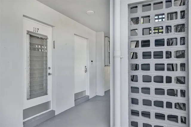 a view of a hallway with wooden shelves