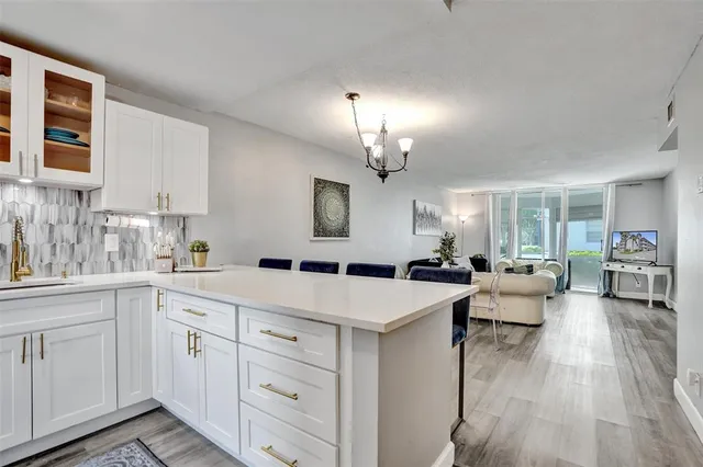 a large white kitchen with cabinets