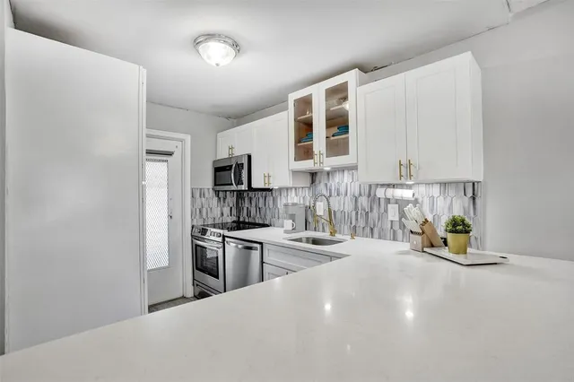 a kitchen with refrigerator and cabinets