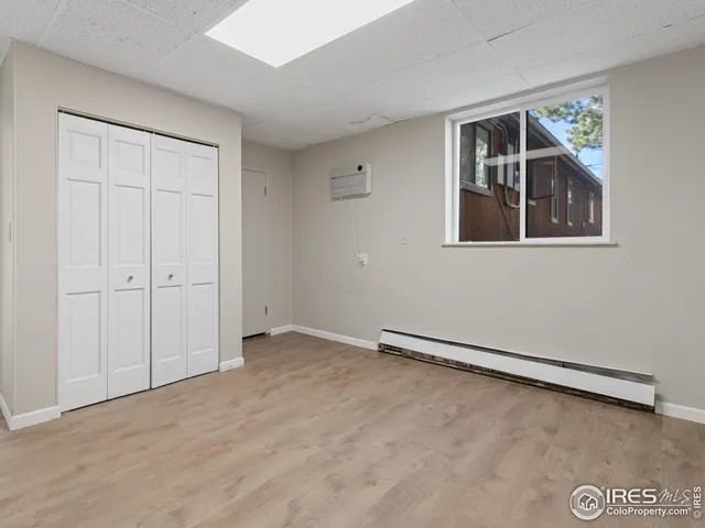 a bedroom with a large bed and a large window