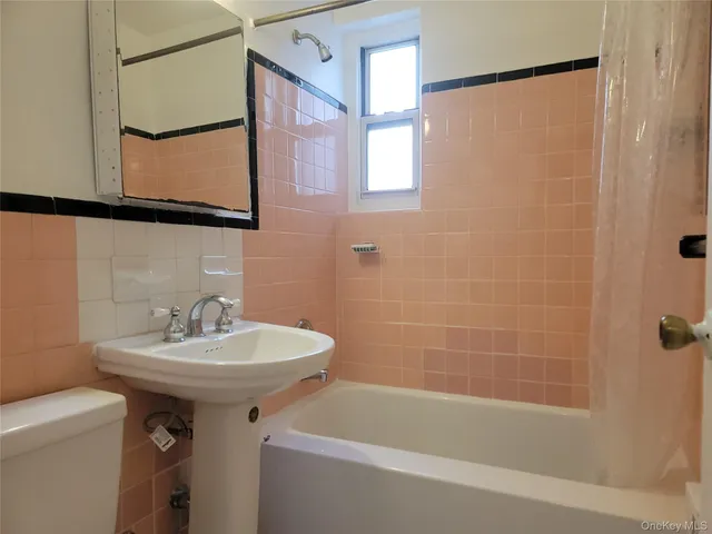 a bathroom with a sink a mirror and a bathtub