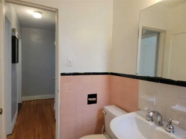 a bathroom with a sink a toilet and mirror