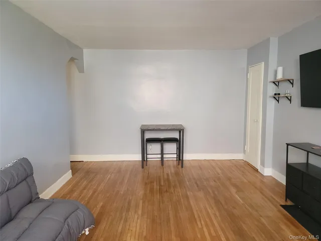 a view of a livingroom with wooden floor and a flat screen tv