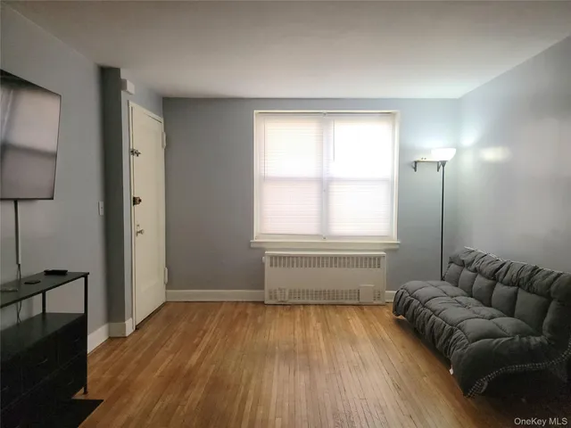 a living room with a couch and a window