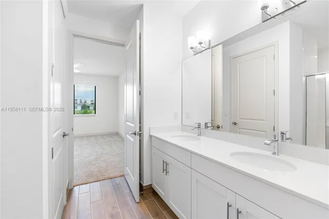 a spacious bathroom with a double vanity sink mirror and double