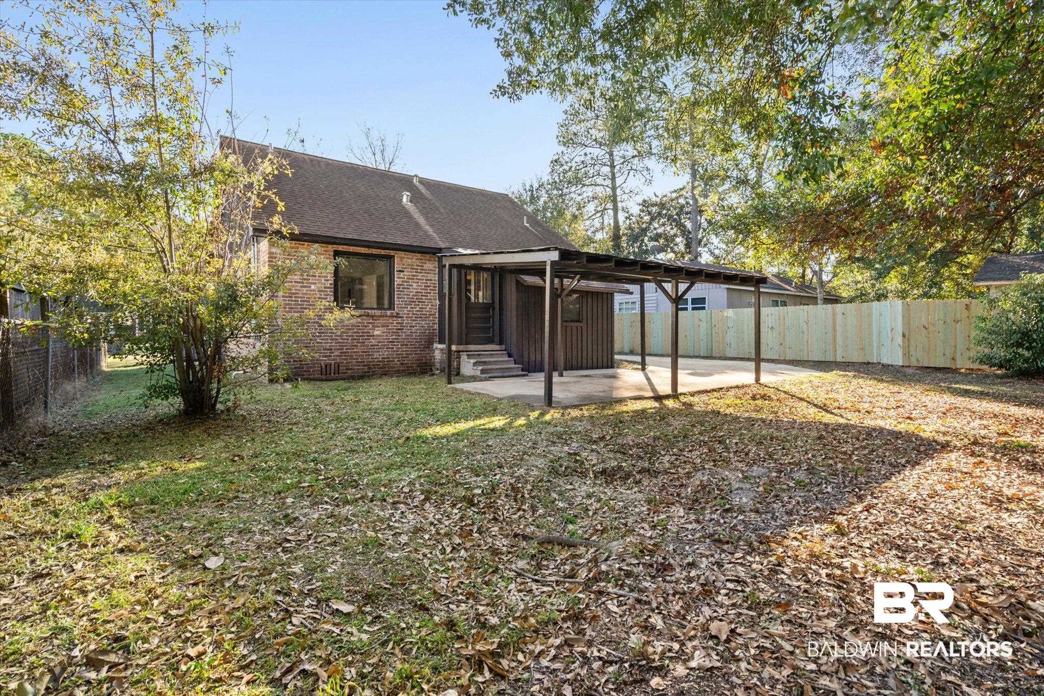 2806 Exter Drive Mobile, AL 36606 - Photo 18 of 24 Back of property with a patio area, a fenced backyard, and brick siding