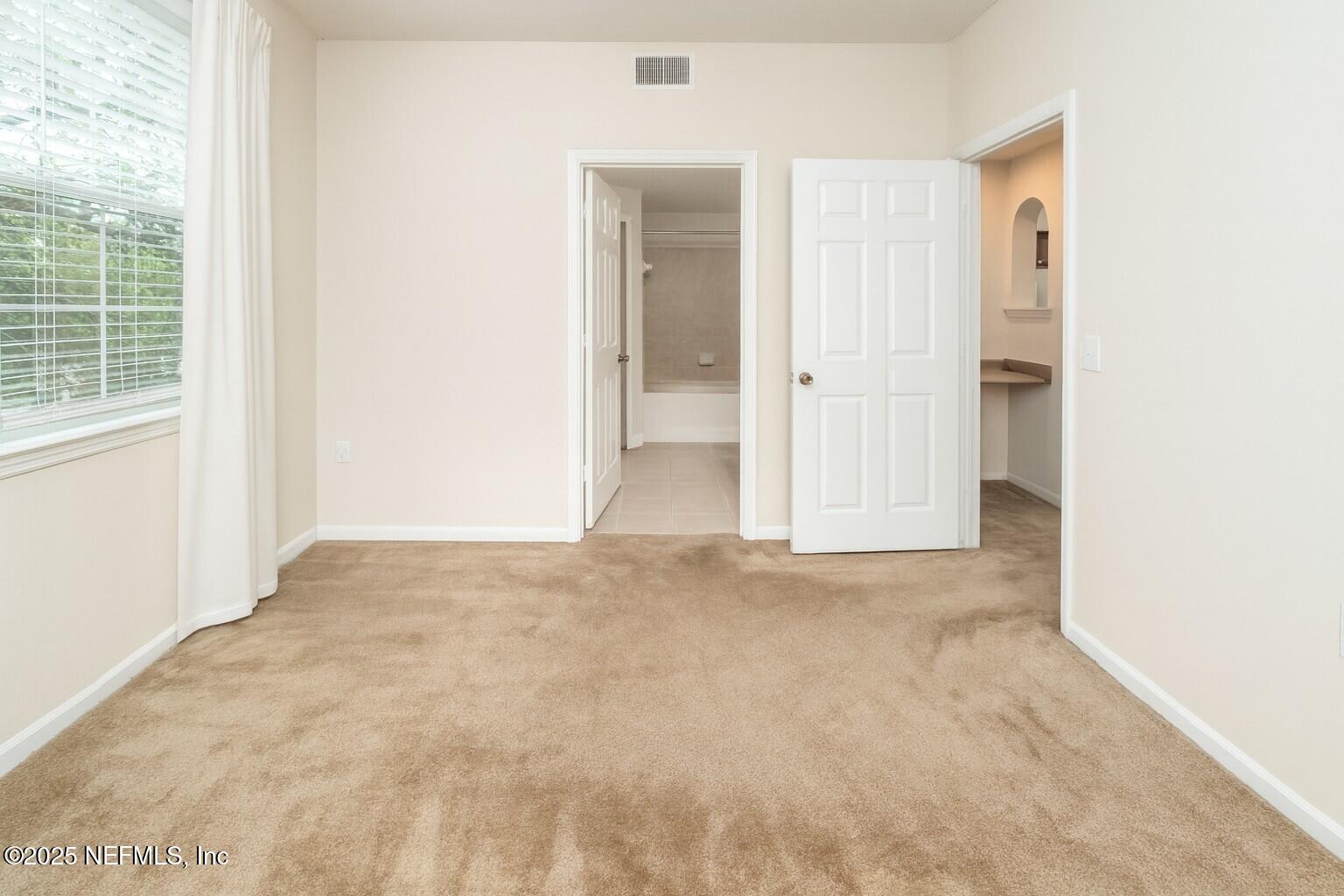8550 Touchton Road, Unit 428 Jacksonville, FL 32216 - Photo 11 of 26 an empty room with windows