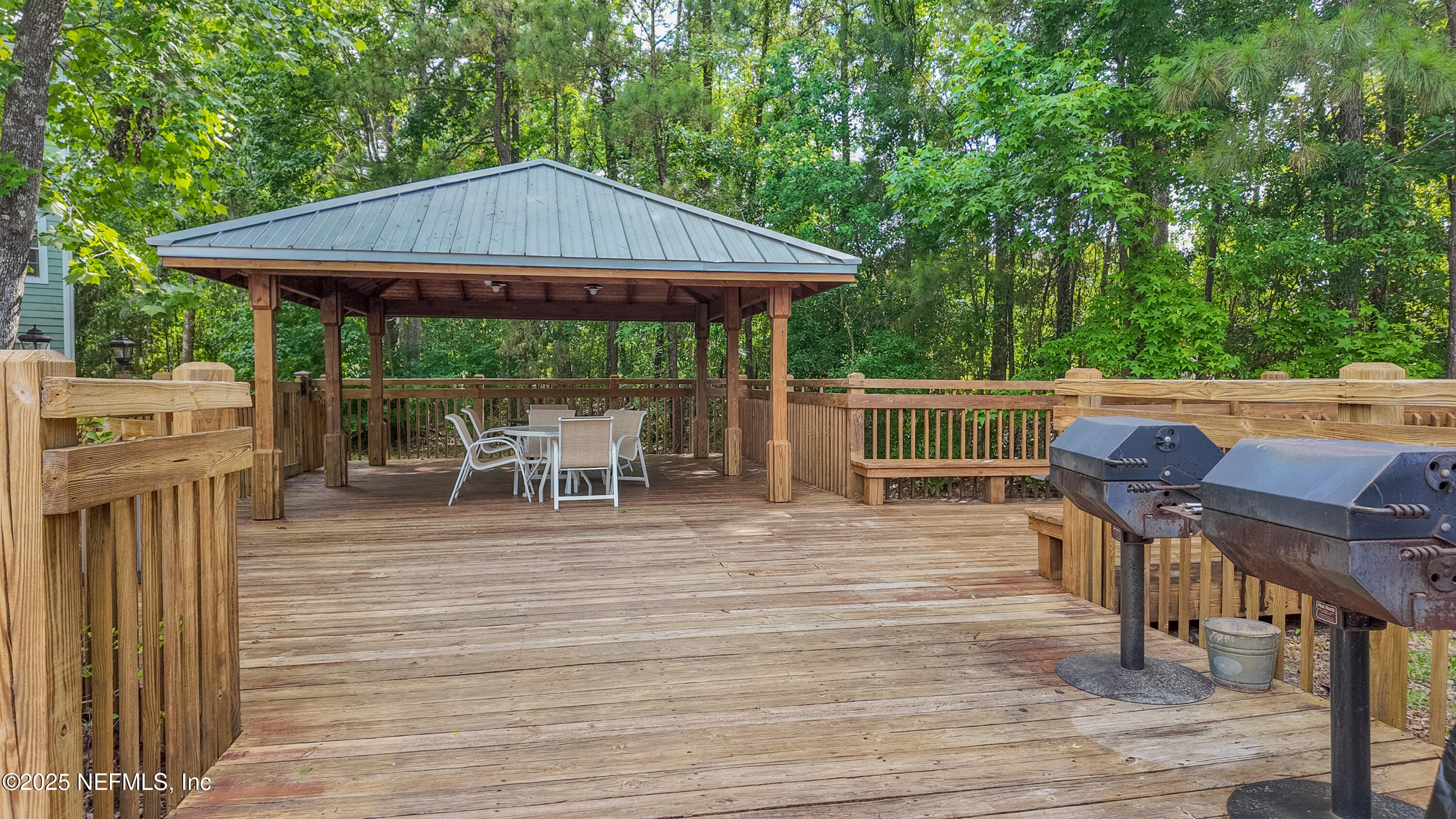 8550 Touchton Road, Unit 428 Jacksonville, FL 32216 - Photo 18 of 26 a patio with wooden floor a yard a table and chairs