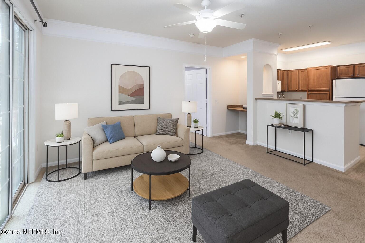 8550 Touchton Road, Unit 428 Jacksonville, FL 32216 - Photo 2 of 26 a living room with furniture and a wooden floor