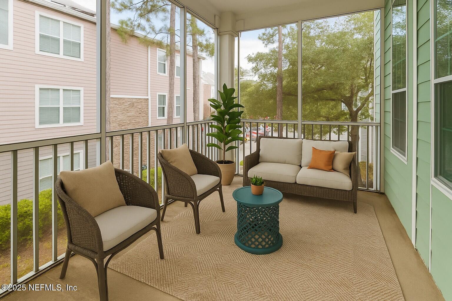 8550 Touchton Road, Unit 428 Jacksonville, FL 32216 - Photo 3 of 26 a balcony with furniture and a potted plant