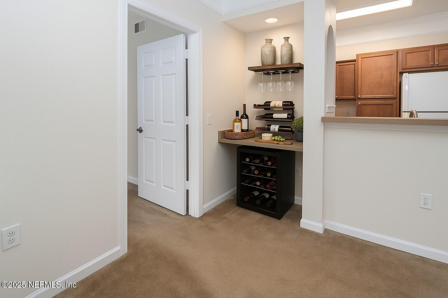 8550 Touchton Road, Unit 428 Jacksonville, FL 32216 - Photo 4 of 26 a kitchen view with granite countertop a refrigerator and cabinets