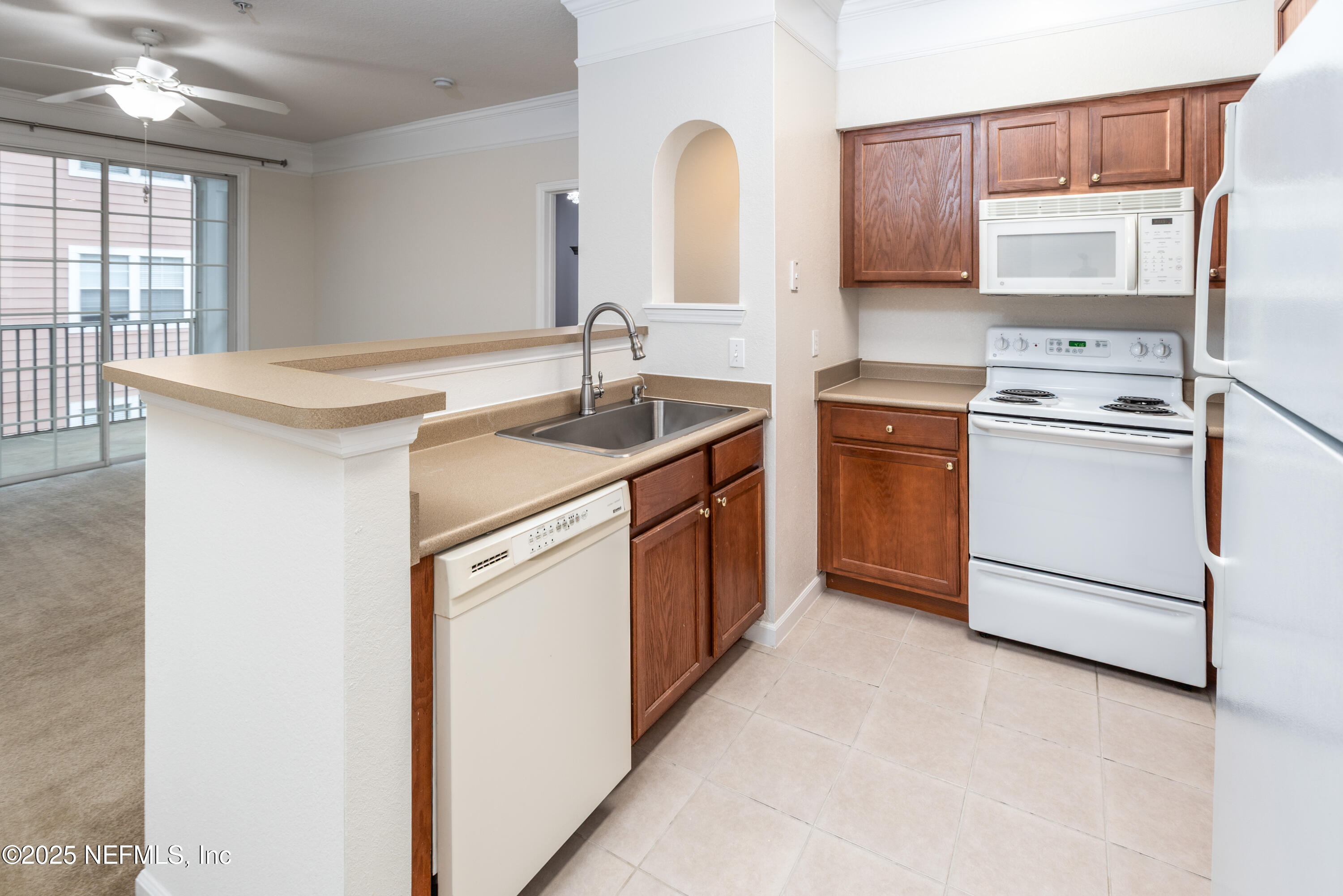 8550 Touchton Road, Unit 428 Jacksonville, FL 32216 - Photo 6 of 26 a kitchen with stainless steel appliances granite countertop a sink stove and refrigerator