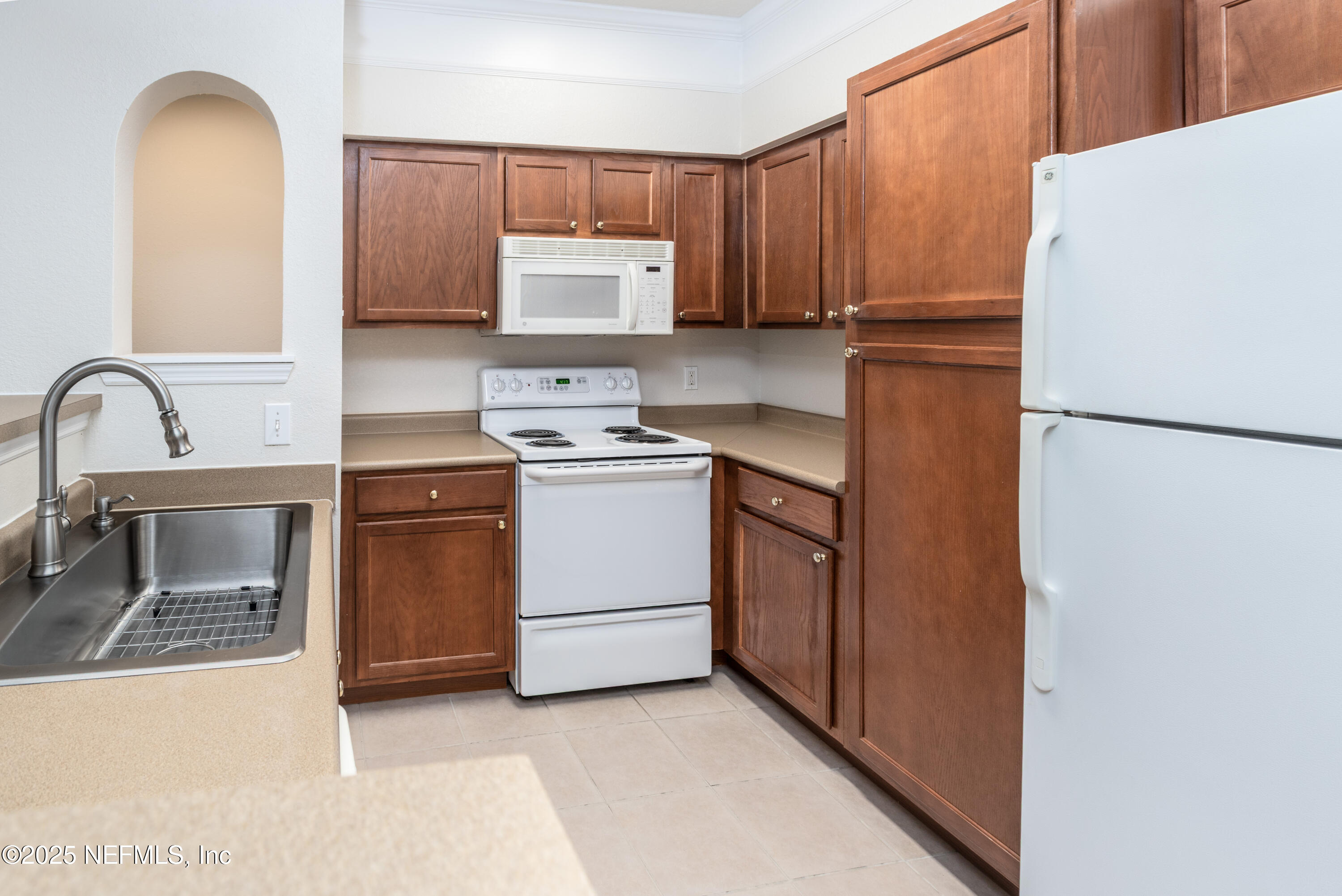 8550 Touchton Road, Unit 428 Jacksonville, FL 32216 - Photo 7 of 26 a kitchen with a refrigerator sink and stove