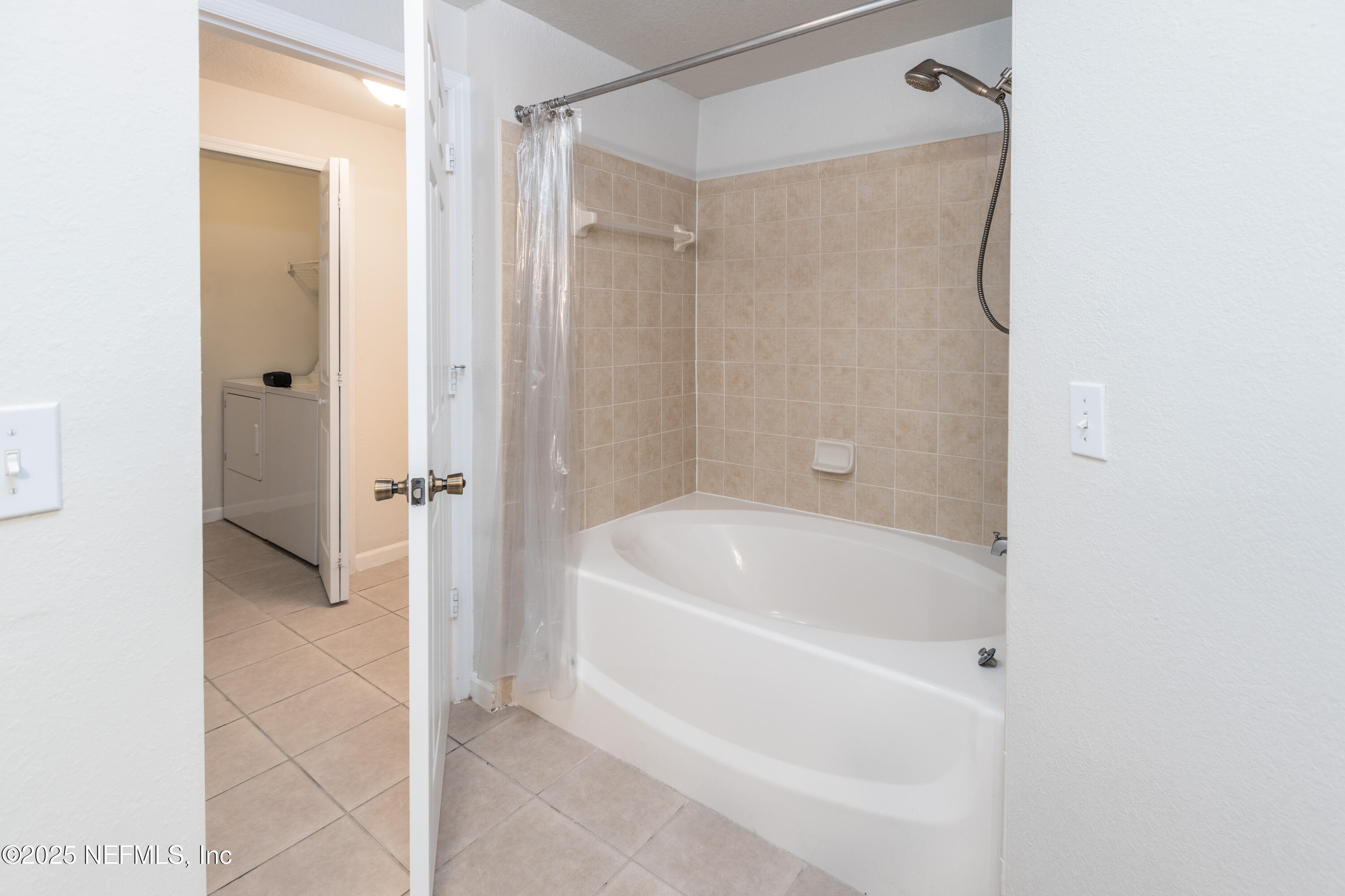 8550 Touchton Road, Unit 428 Jacksonville, FL 32216 - Photo 10 of 26 a bathroom with a tub shower and a sink