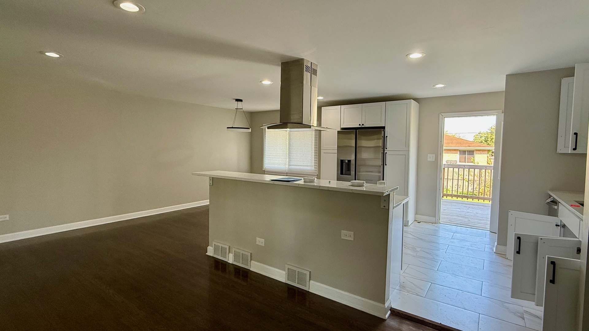 2958 191st Street Lansing, IL 60438 - Photo 3 of 25 an open kitchen with wooden floor and window