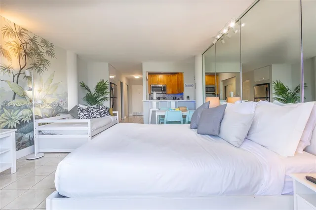 a large white bed in a hotel room