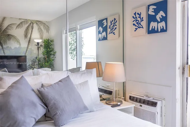 a bedroom with a bed and a lamp