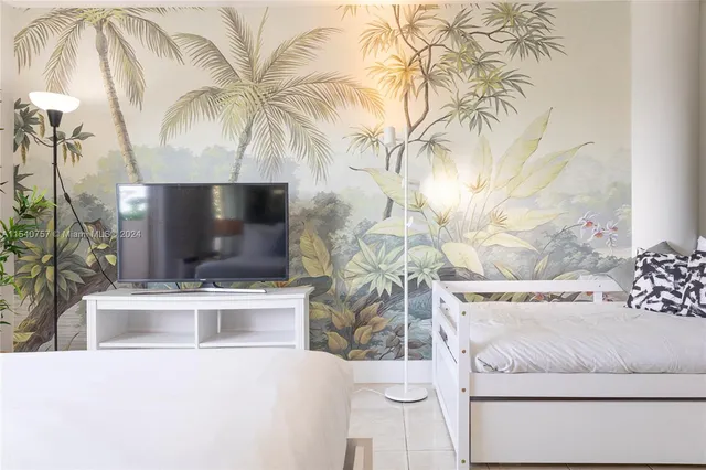 a living room with a couch and a potted plant