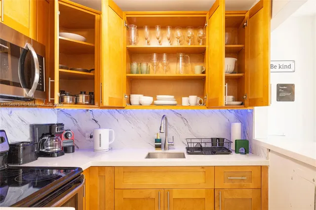 a kitchen with a sink and a stove next to a window