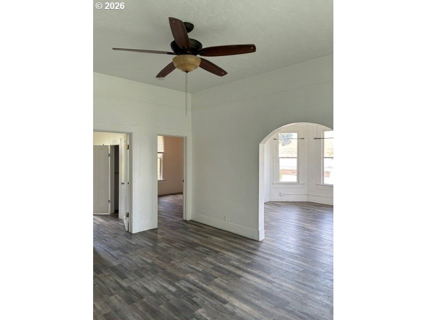 1914 Southeast Court Avenue Pendleton, OR 97801 - Photo 3 of 28 a view of a hallway with a chandelier fan and wooden floor