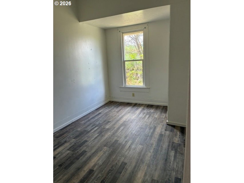 1914 Southeast Court Avenue Pendleton, OR 97801 - Photo 10 of 28 a view of an empty room with wooden floor and a window