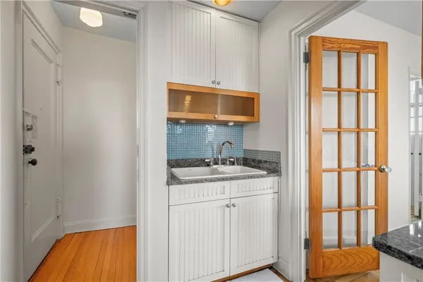 a kitchen with a sink stove and cabinets