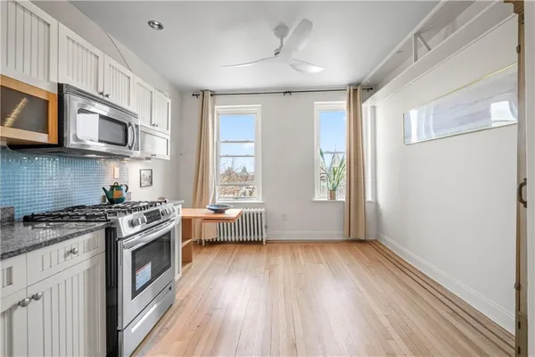 a kitchen with stainless steel appliances a stove a sink and a microwave