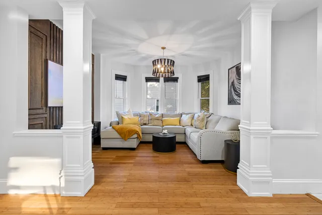 a living room with fireplace furniture and a chandelier