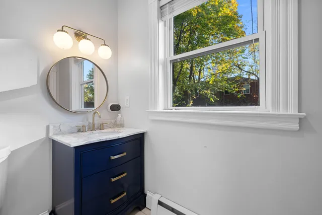 a bathroom with a toilet and a mirror