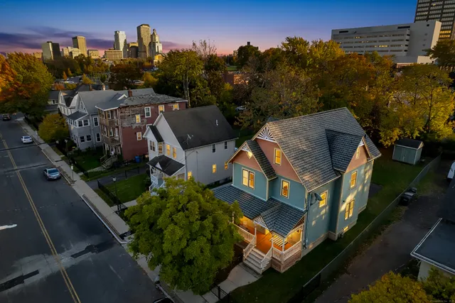 an aerial view of multiple houses with a yard