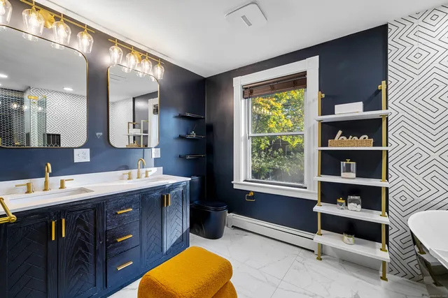 a bathroom with a sink mirror and a window